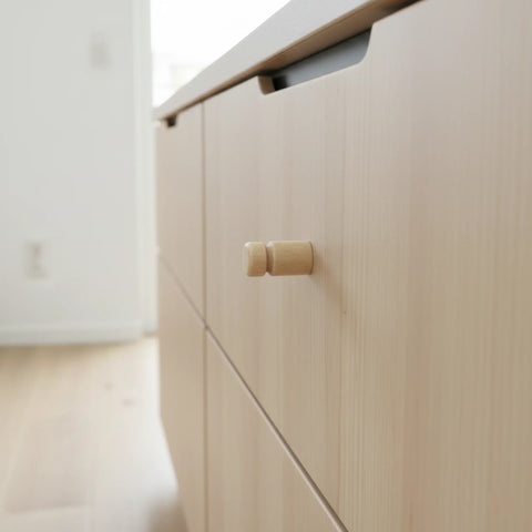 Close-up of 25 mm turned wooden peg cabinet knob showing wood grain